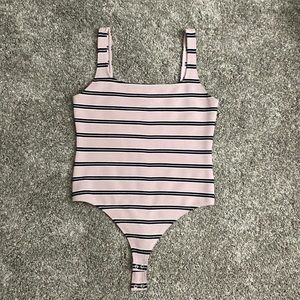Square neck bodysuit with thong back and snap bottom.